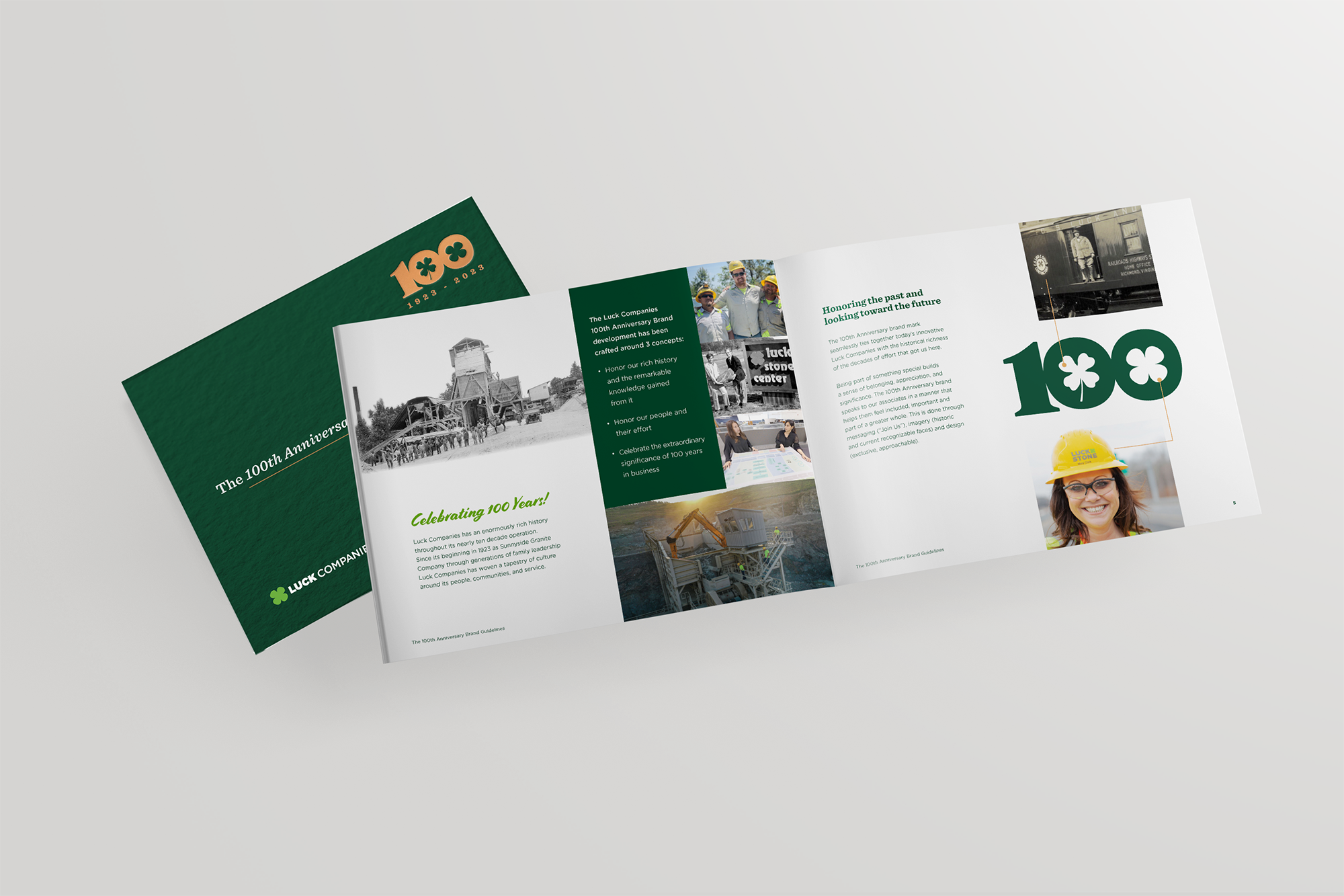 Open booklet spread celebrating the 100th anniversary of Luck Companies, featuring historical company photos, a timeline, and a woman wearing a yellow safety helmet.