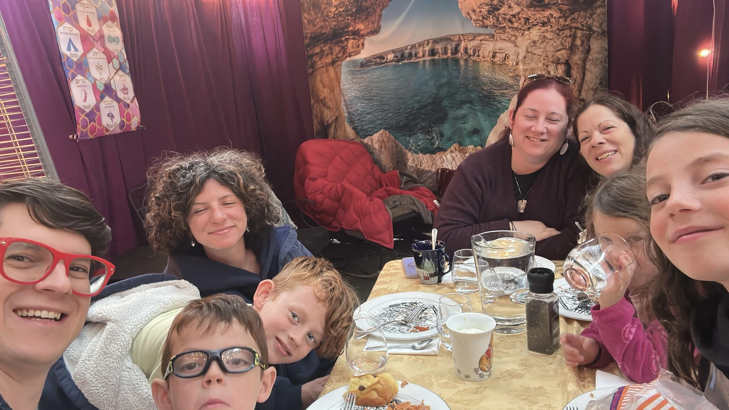 Linda Perry PMHNP-BC CNM with her multigenerational family gathered around a table, reflecting over three decades of clinical experience caring for patients in NJ NY and MD