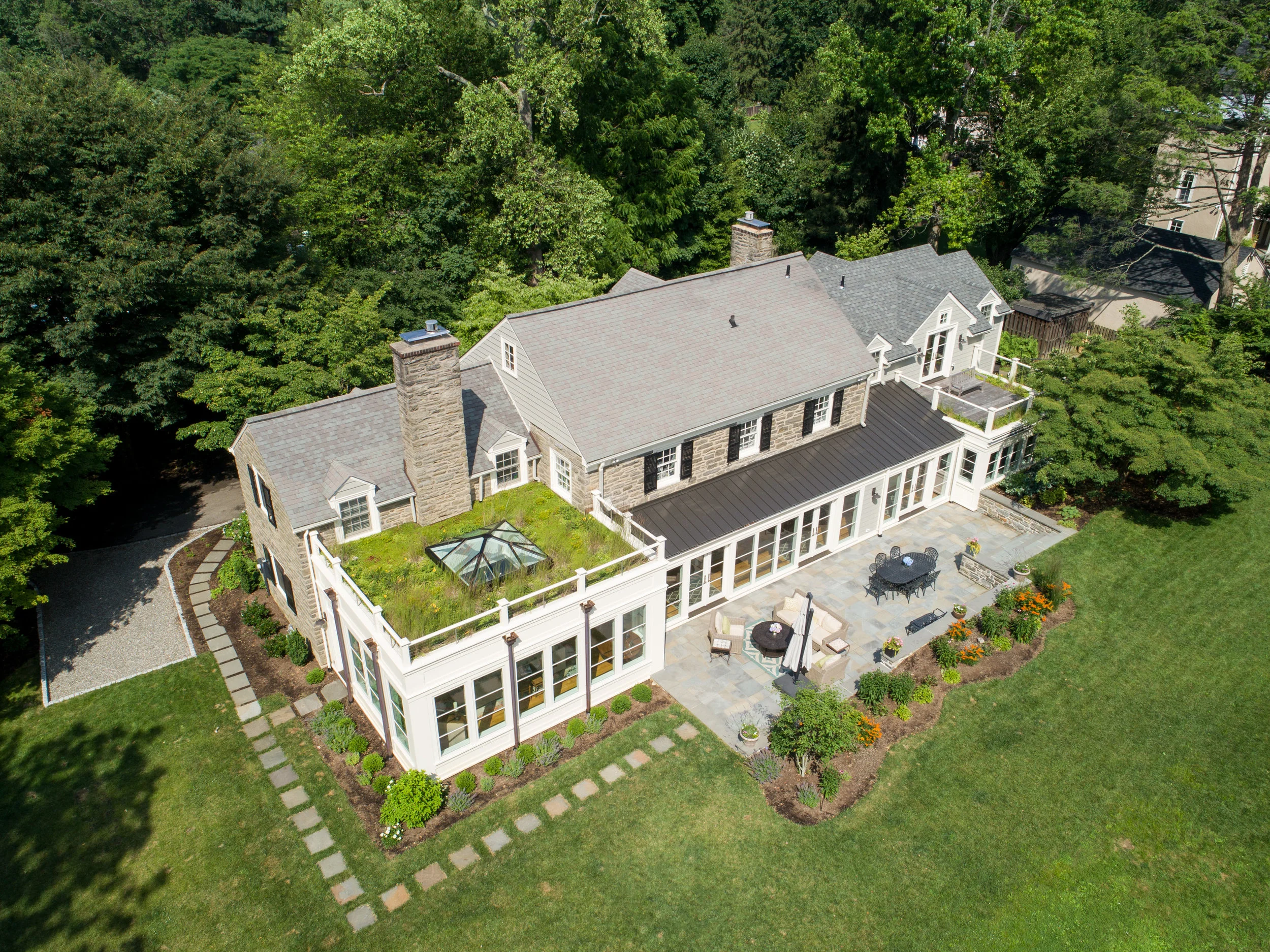 Functional green roofs and a generously proportioned patio blur the lines between indoors and out.
