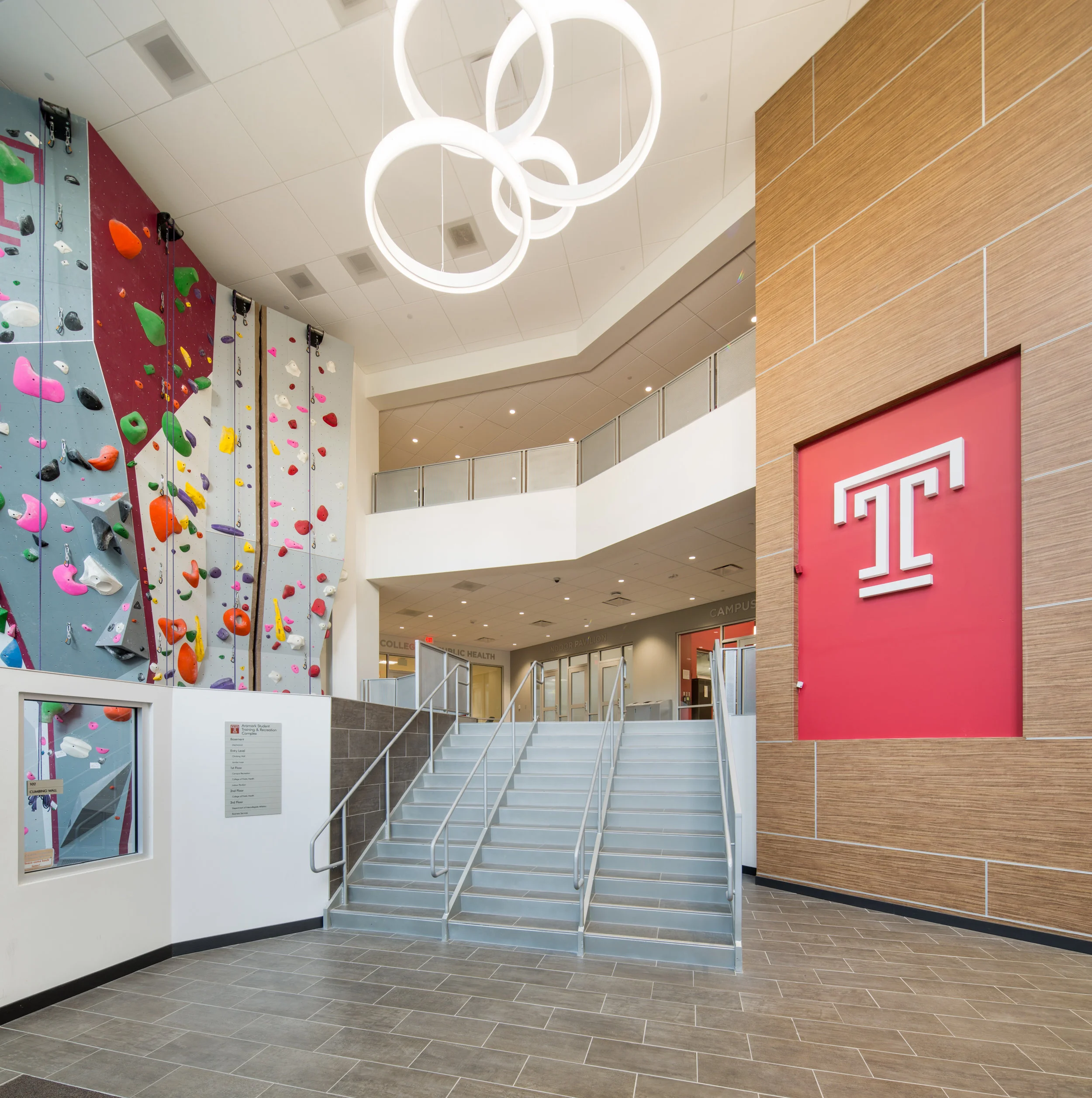 We used a very wide architectural tilt-shift lens to fully show the two-and-a-half-story glass atrium entrance with climbing wall.