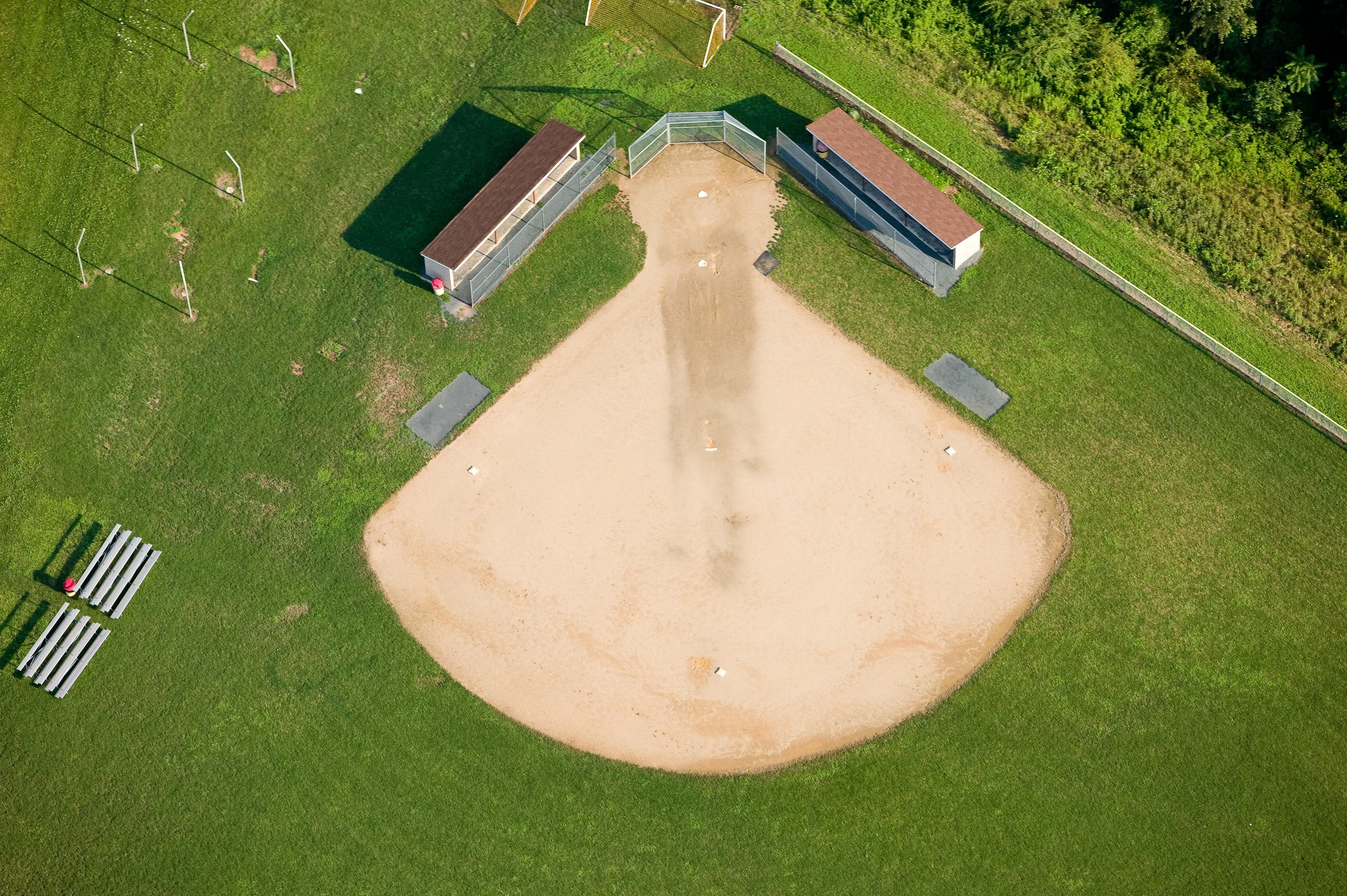 Softball fields lack the inner field grass of baseball fields.