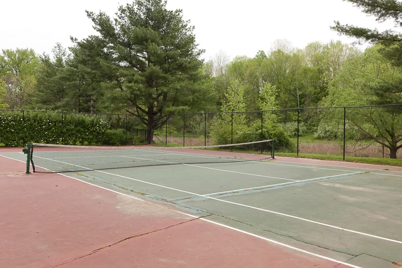 BEFORE: The old tennis court was poorly maintained and under-utilized.