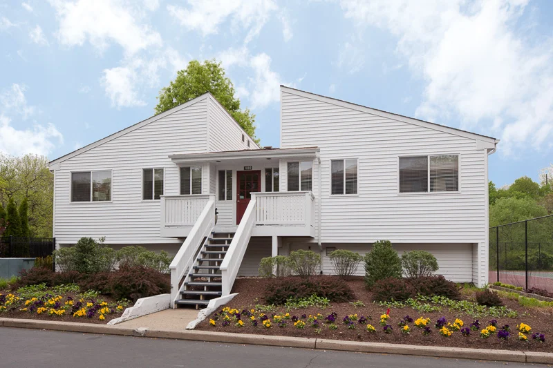 BEFORE: The old clubhouse, clad in “blah” white vinyl, was attracting no one with its outdated styling.