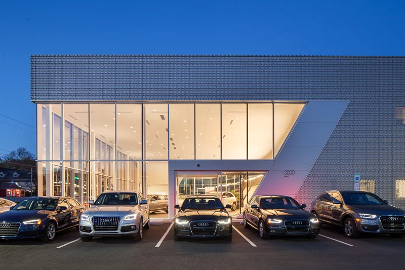 The sophisticated design of the showroom matches the luxury automobiles on display.