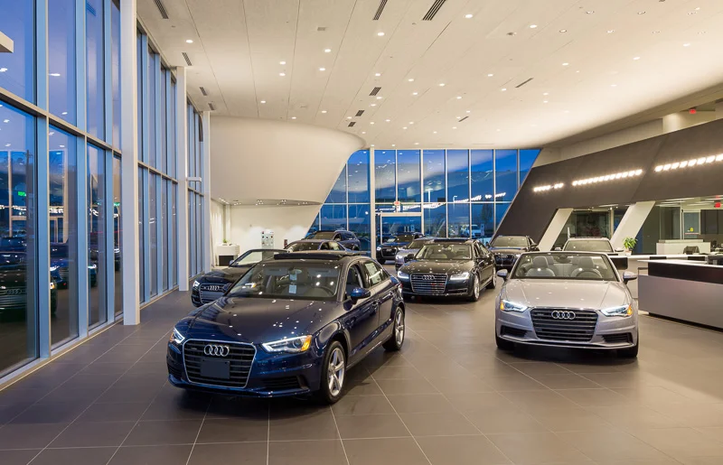 Vehicles are displayed like works of art in a modern gallery.