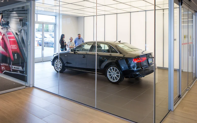 Customers take delivery of their new Audi in a custom-designed glass room — a truly special moment, above and beyond a typical car-buying experience.