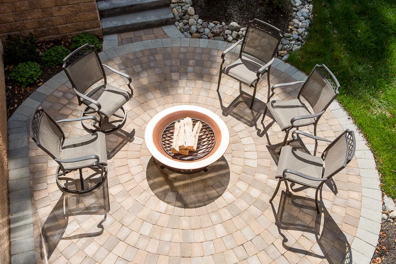 A firepit sits poised for sundown, ready to draw guests into casual conversation.