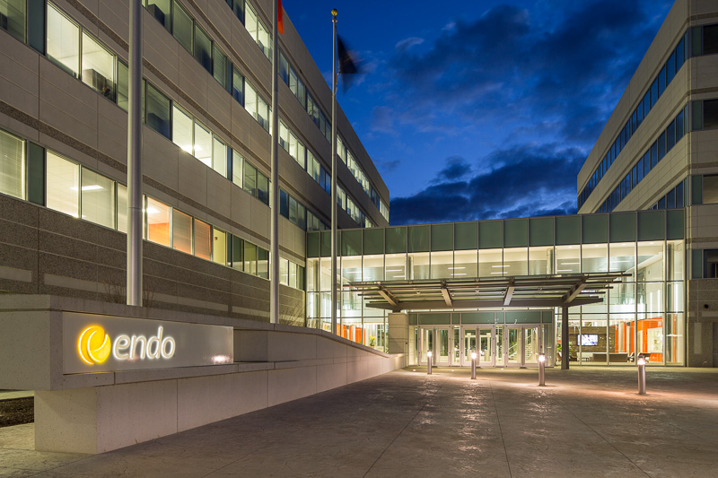 A darkened sky draws your eye to the entryway connecting these two buildings.