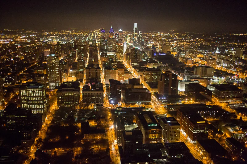 Philadelphia turns into glowing pockets of light when photographed from above at night.
