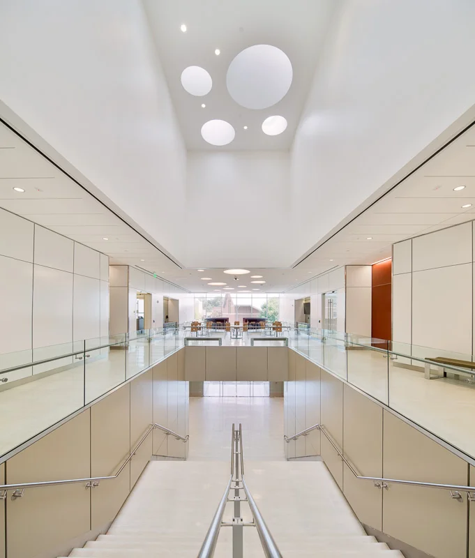 Main stairwell and common space with circular skylights above.
