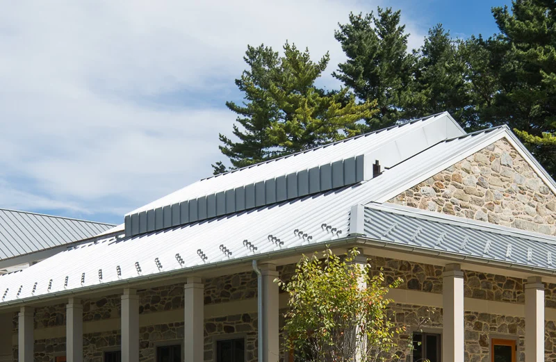 The metal roof of the meetinghouse uses motors to slide open.