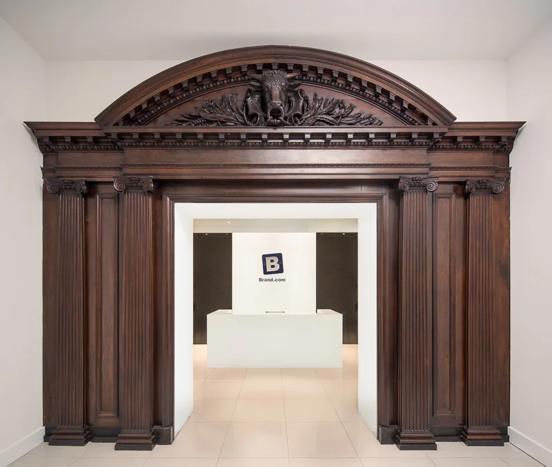 Historic wood pediment frames the doorway to the digital firm Brand.com.
