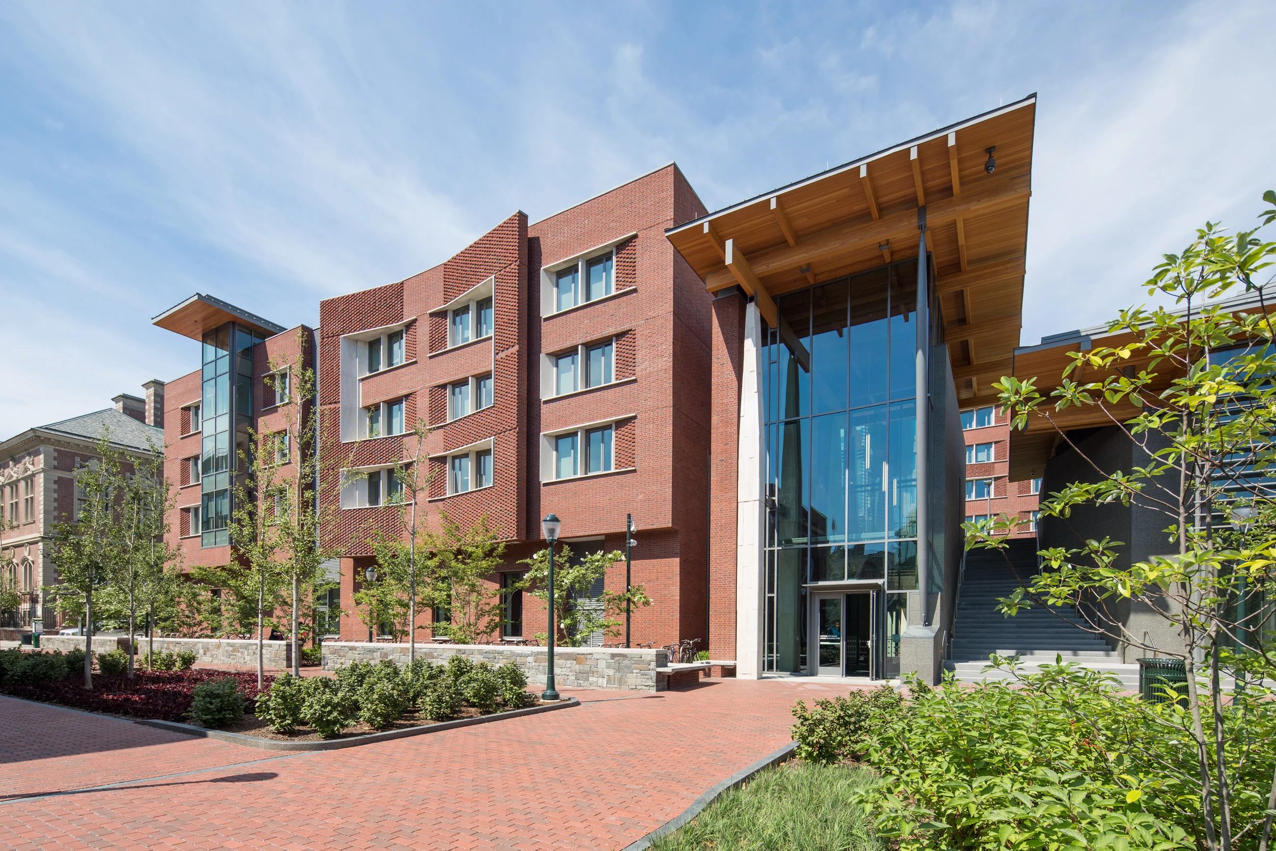 Timber and concrete lend a somewhat rustic, but sophisticated feel to the building’s main entrance, one that complements the meticulous landscaping.