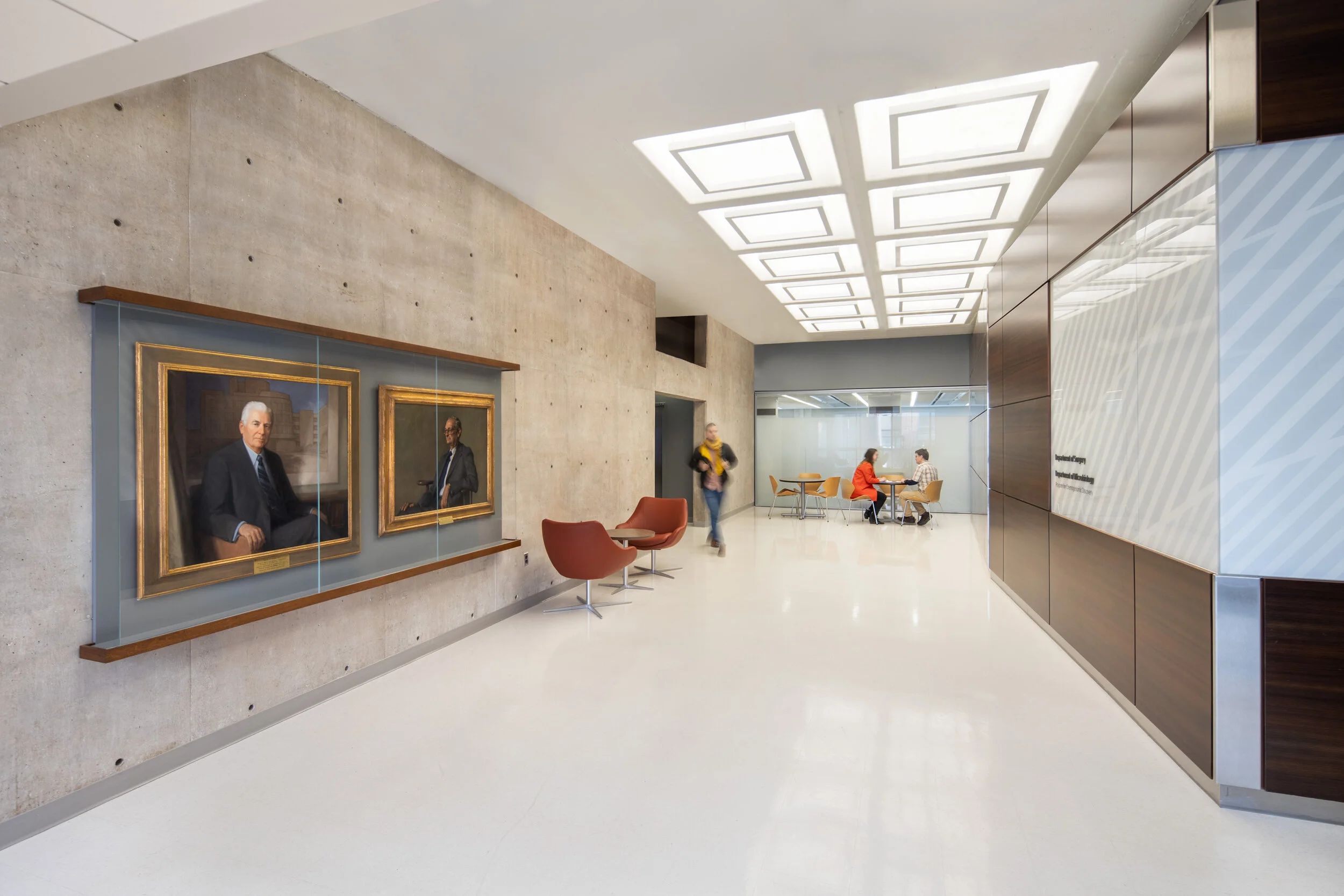 Common spaces showcase historic portraits adjacent to contemporary signage.