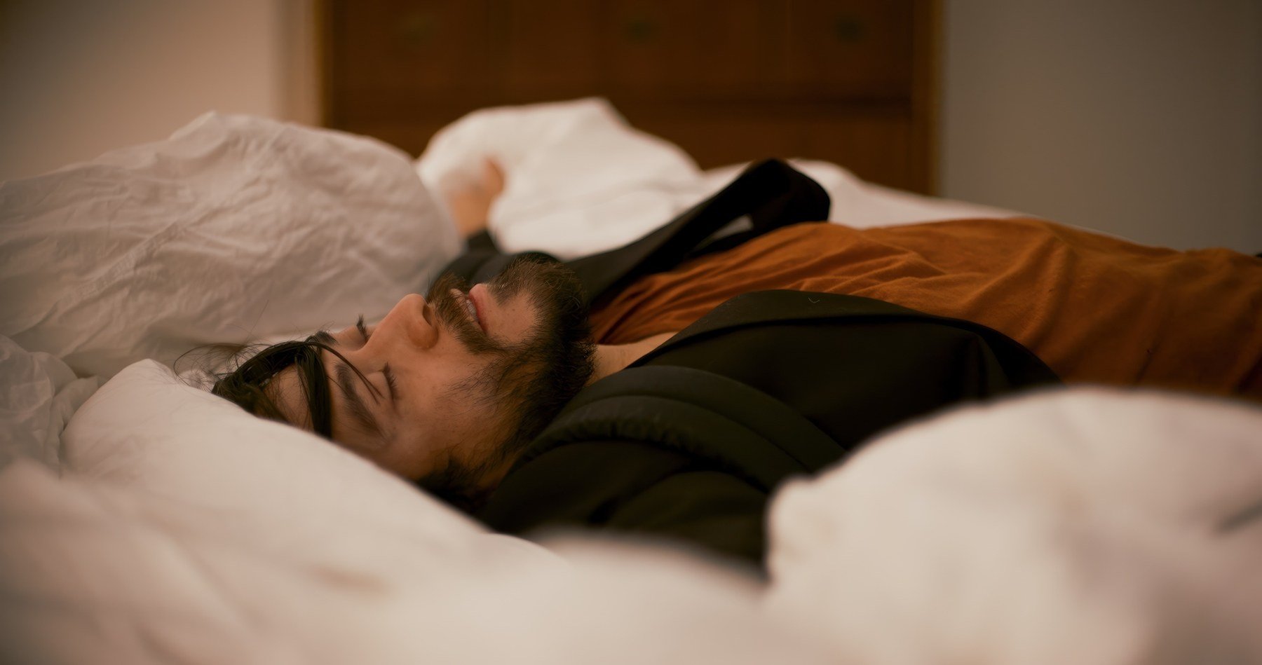 Bloodworm short film still — Kai Wen Hu - The Drifter lies in the luxurious bed of the man whose identity he's stolen.