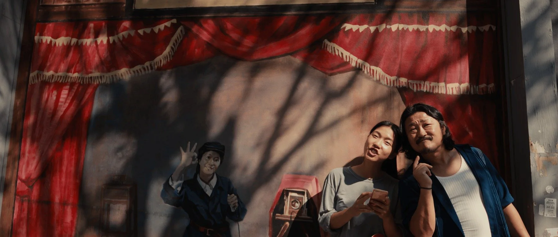 Pedigree short film still - Kai Wen Hu - Samuel and Squid stand in front of a mural in Flushing, New York.