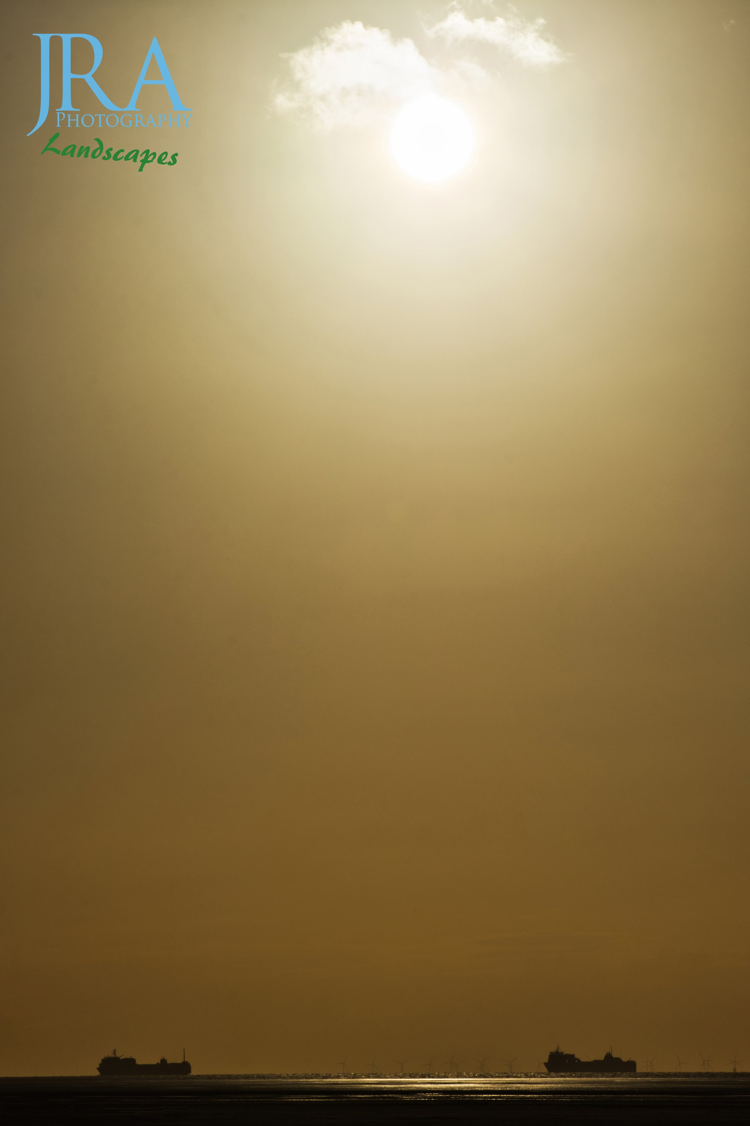 Cargo ships under the setting sun WM.jpg