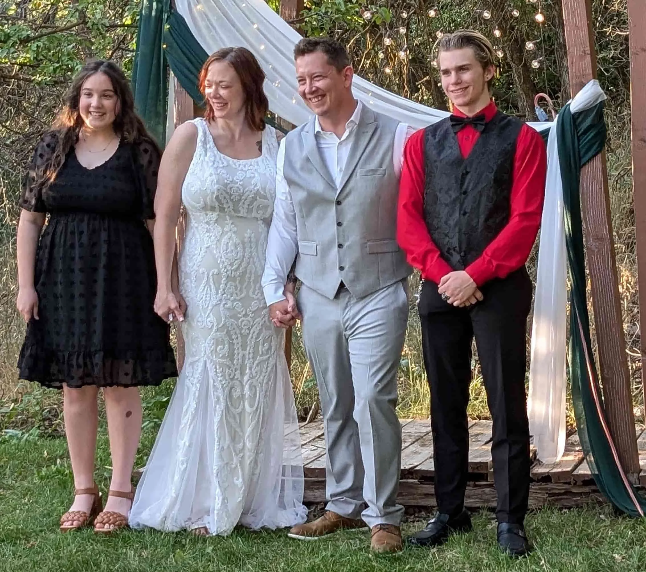 Owner Joshua posing with family at wedding