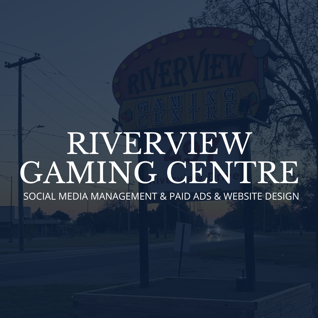 Riverview Gaming Center sign with trees and a road in the background at dusk.