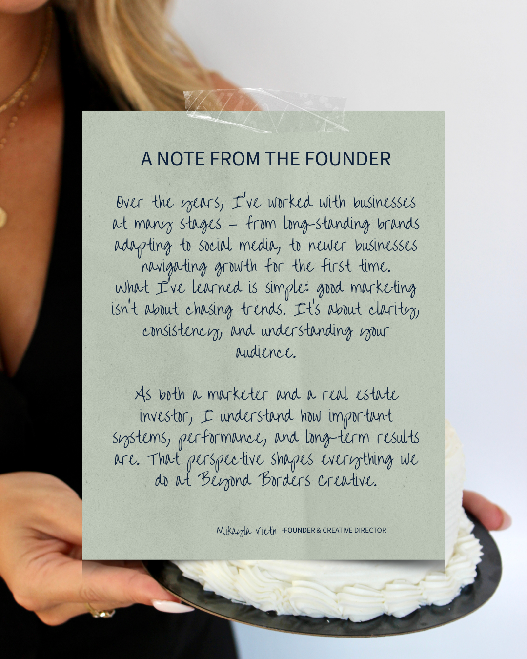 A note from the founder on a light green paper with handwritten text, held up by a person with blonde hair, wearing a black top, against a neutral background. The note discusses marketing experience and lessons learned.