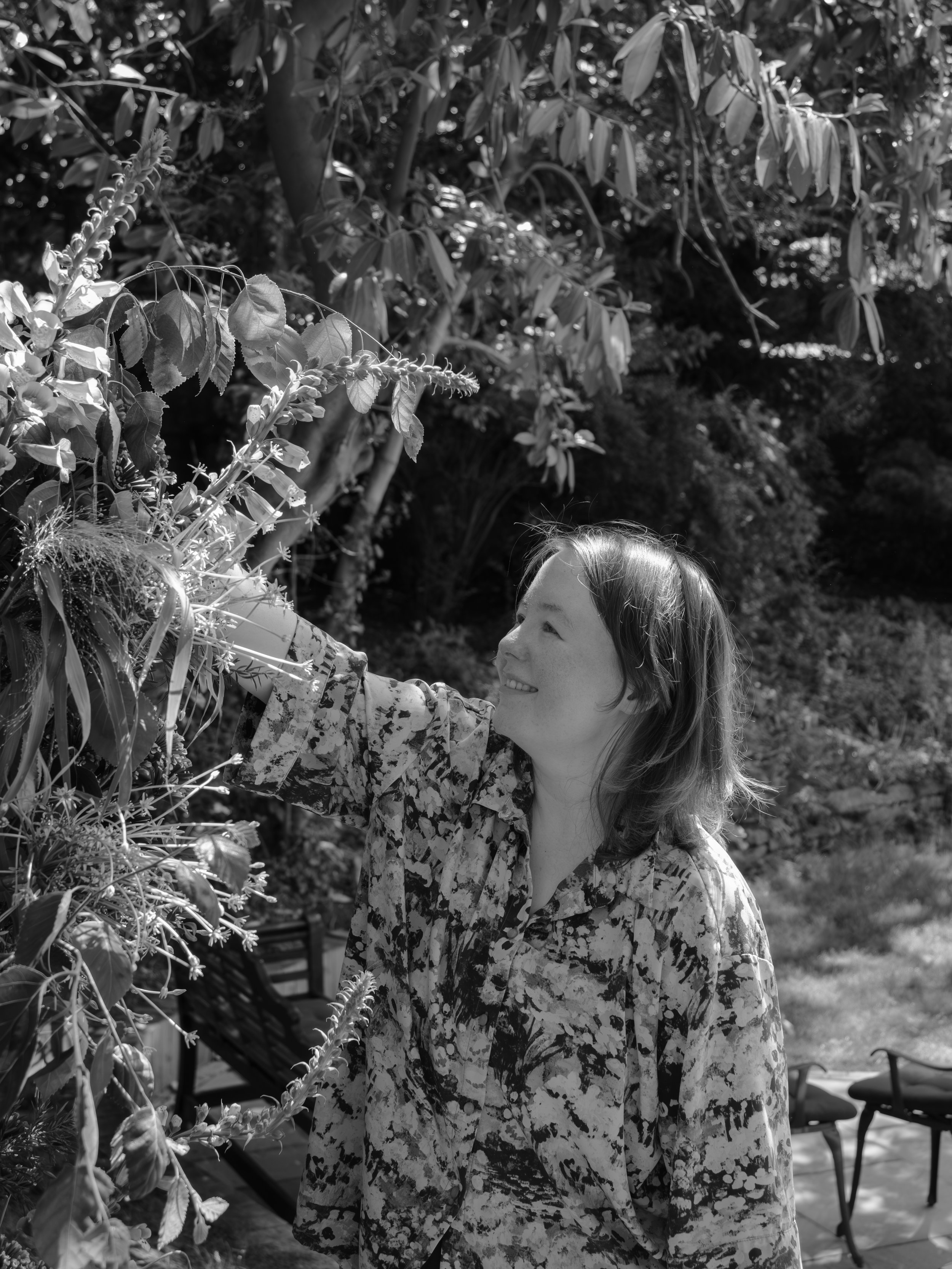 A picture of Jodie, head florist, working on an installation in the grounds of Ecton House. Shot by Another Muse Photography