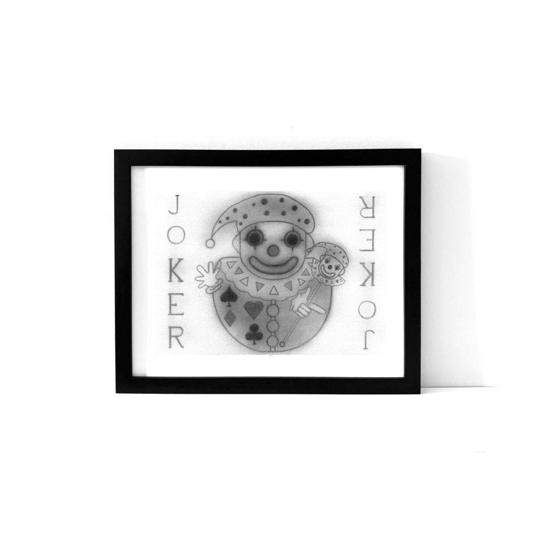 An art print featuring the image of The Joker from a pack of playing cards.