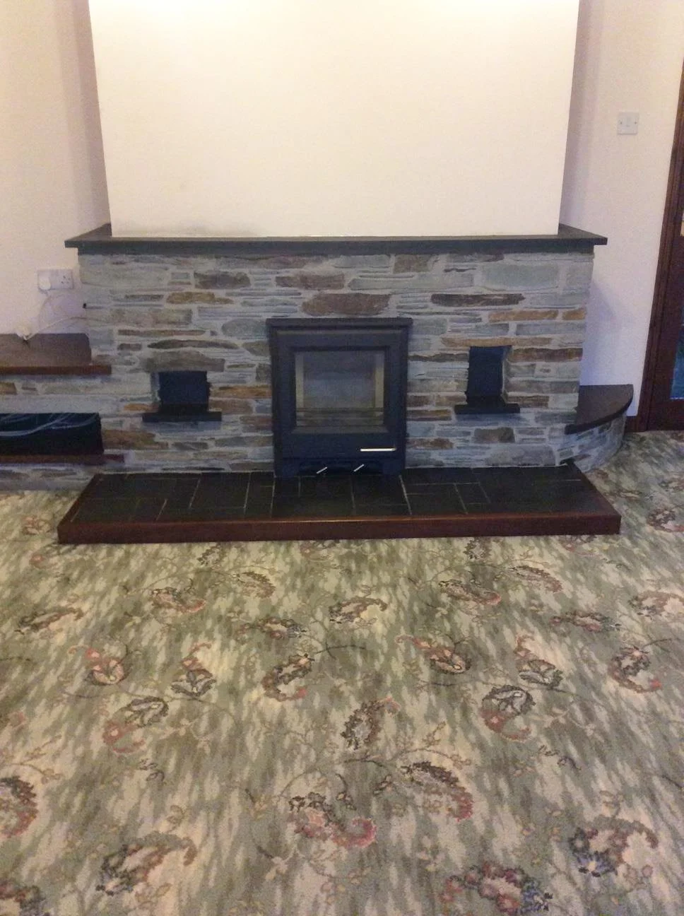 Woodwarm in traditional Cornish slate fireplace