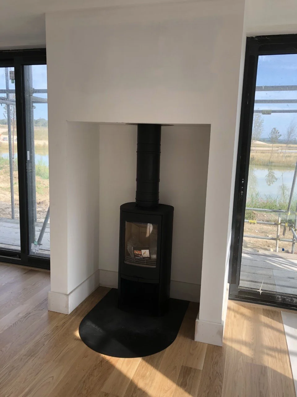 Freestanding Contura in a clean fireplace in a new build 