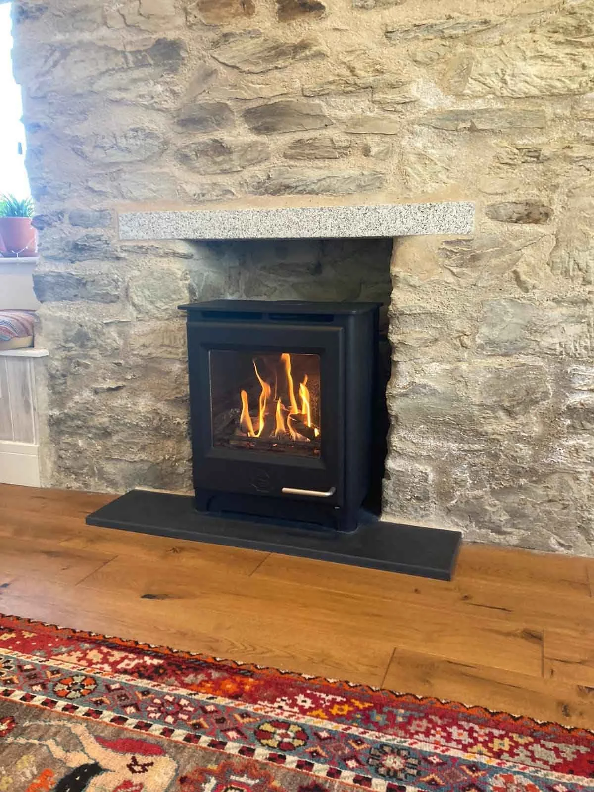 Traditional Cornish stone fireplace with Woodwarm logburner