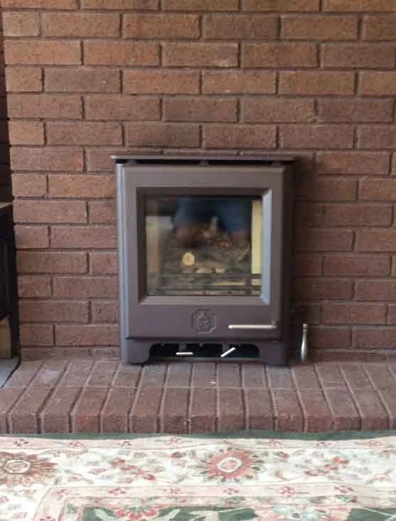 Inset woodwarm logburner into a brick fireplace