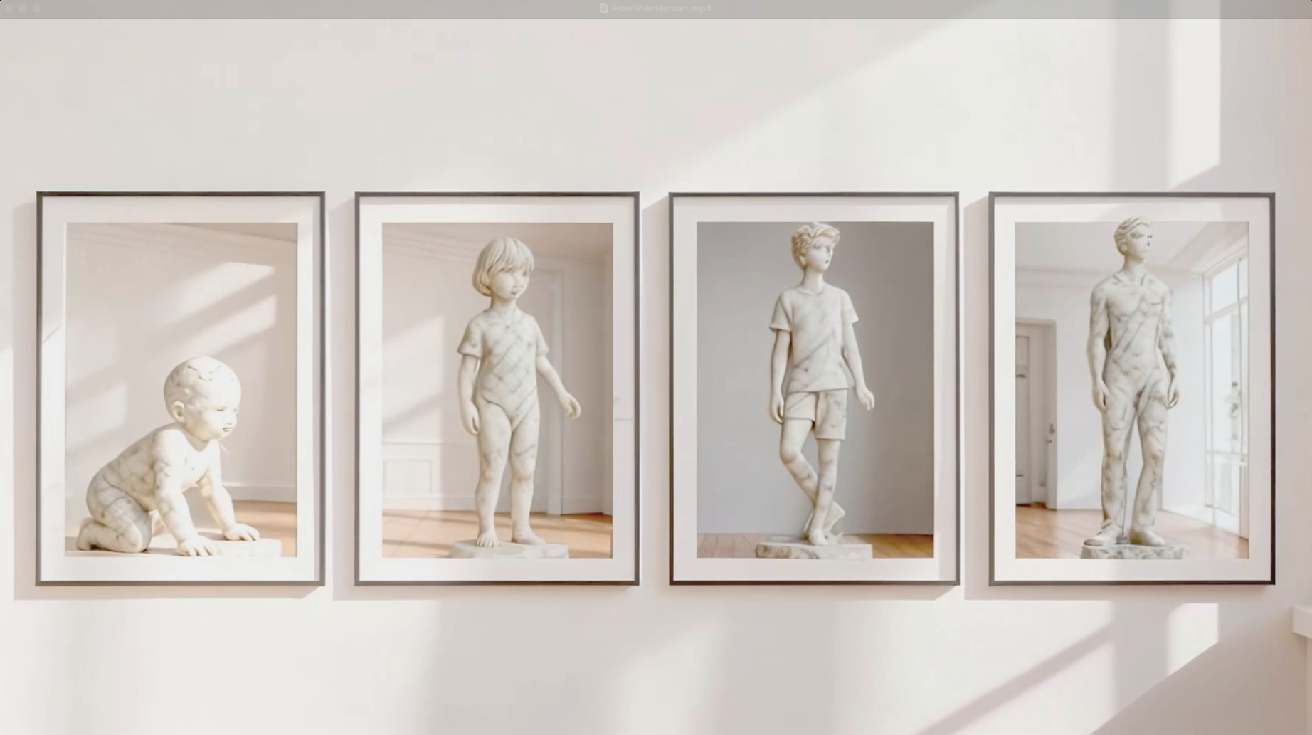 Four framed photographs of marble sculptures of children and young adults on a gallery wall.