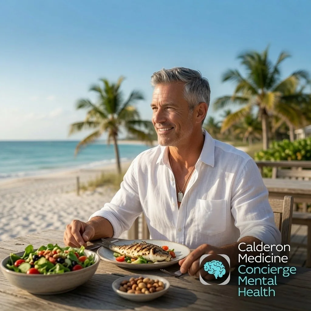 Fit mature man enjoying Mediterranean diet meal with grilled fish, fresh salad and nuts on a sunny Florida beach, representing mental clarity and physical vitality through root-cause nutrition at Calderon Medicine Concierge Mental Health