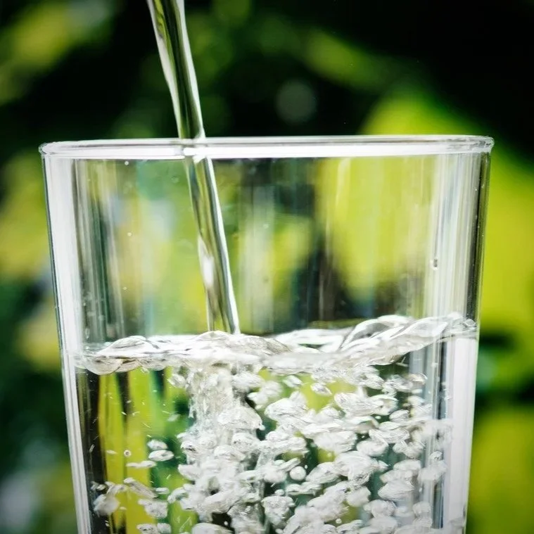 Clean drinking water being poured into a glass, a reminder from KoKo To Vision Coaching about life’s simplest nourishment.