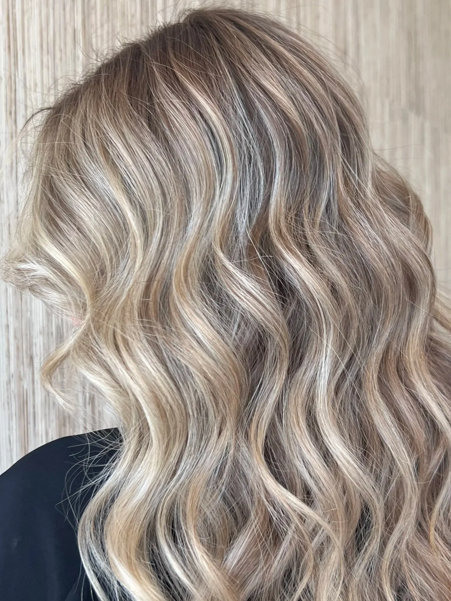 Close-up of blonde, wavy, highlighted hair.