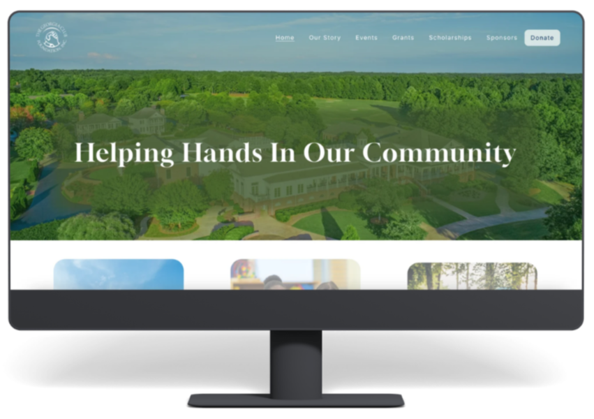 A computer monitor displaying a website for a community organization with the header 'Helping Hands in Our Community' and a background image of a lush green landscape with trees and buildings.