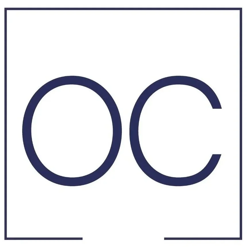 Close-up of a white background with the bold, dark blue letters 'OC' in the center.