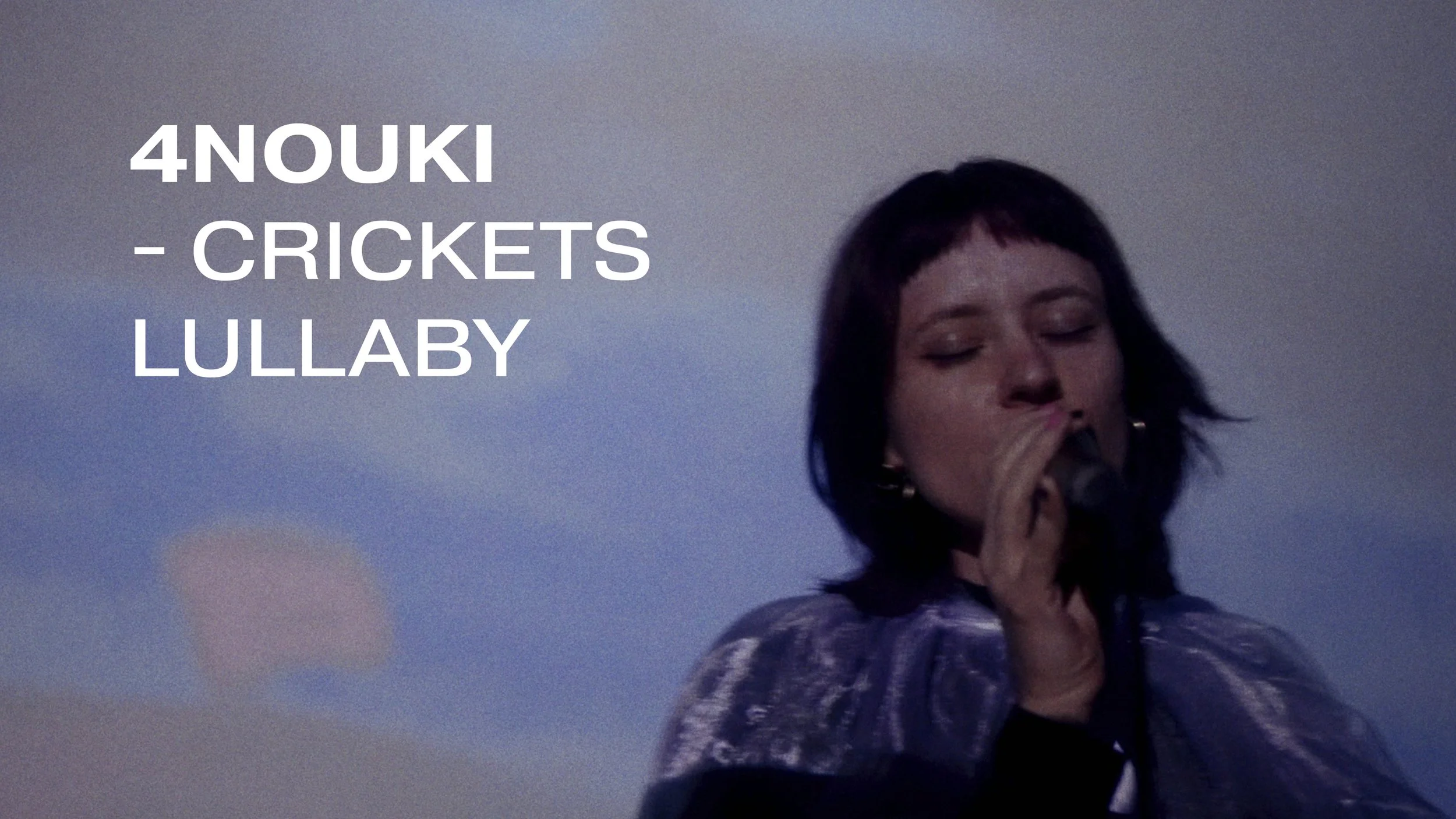 A woman singing into a microphone against a blue sky background with pink clouds, with text overlay stating '4NOUKI - CRICKETS LULLABY'.