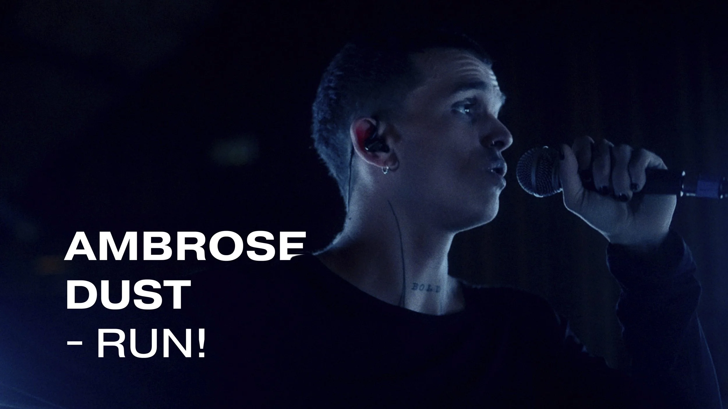 A man singing into a microphone against a dark background with blue lighting, with text that reads 'Ambrose Dust - RUN!'.