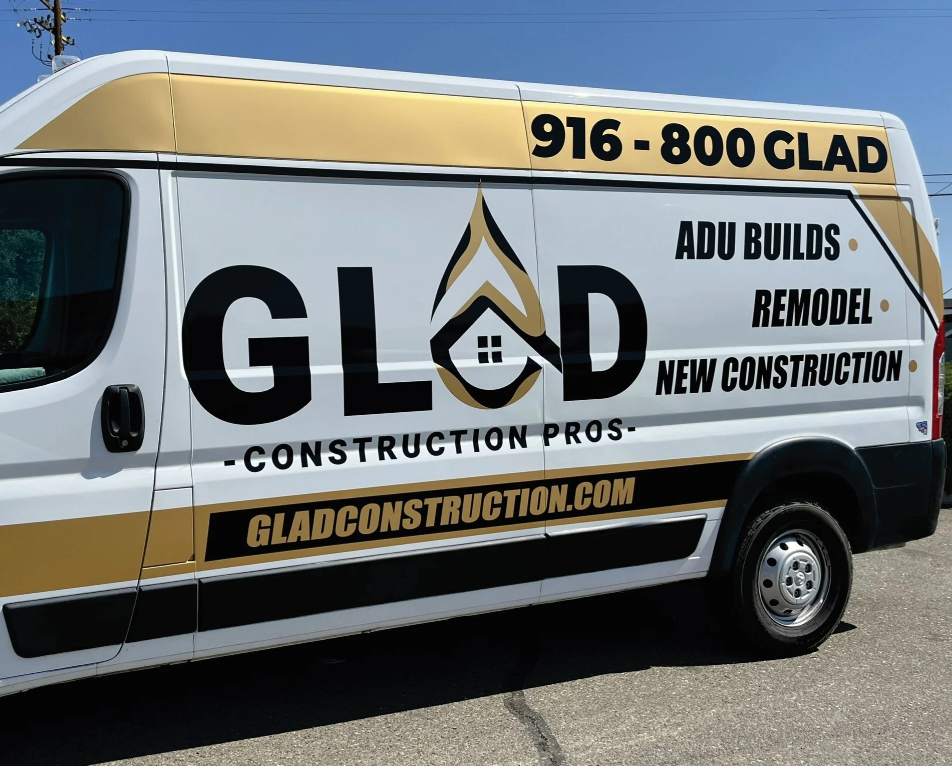 White construction van with GLAD Construction Pros branding and contact information, advertising services like ADU builds, remodeling, and new construction.