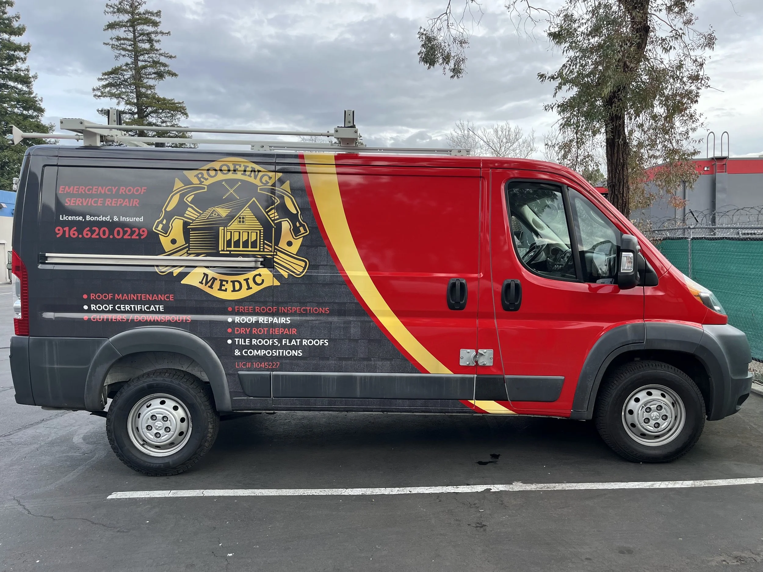 Red service van with roofing company branding, displaying phone number, services like roof repair, maintenance, and inspections, with a large logo featuring a house, shingles, and tools.