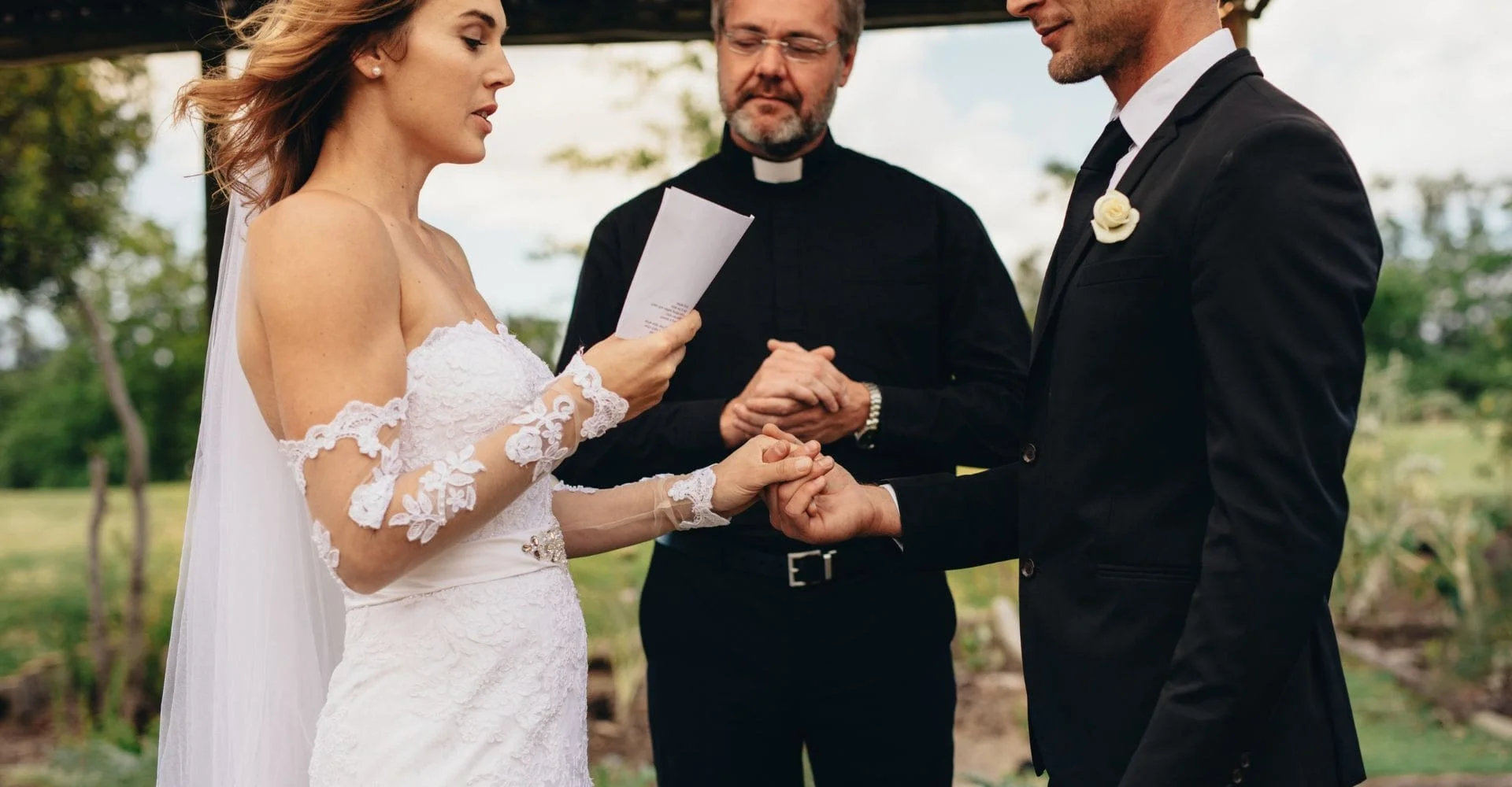 An enchanting wedding ceremony in a garden, showcasing a couple exchanging vows amidst vibrant floral decorations