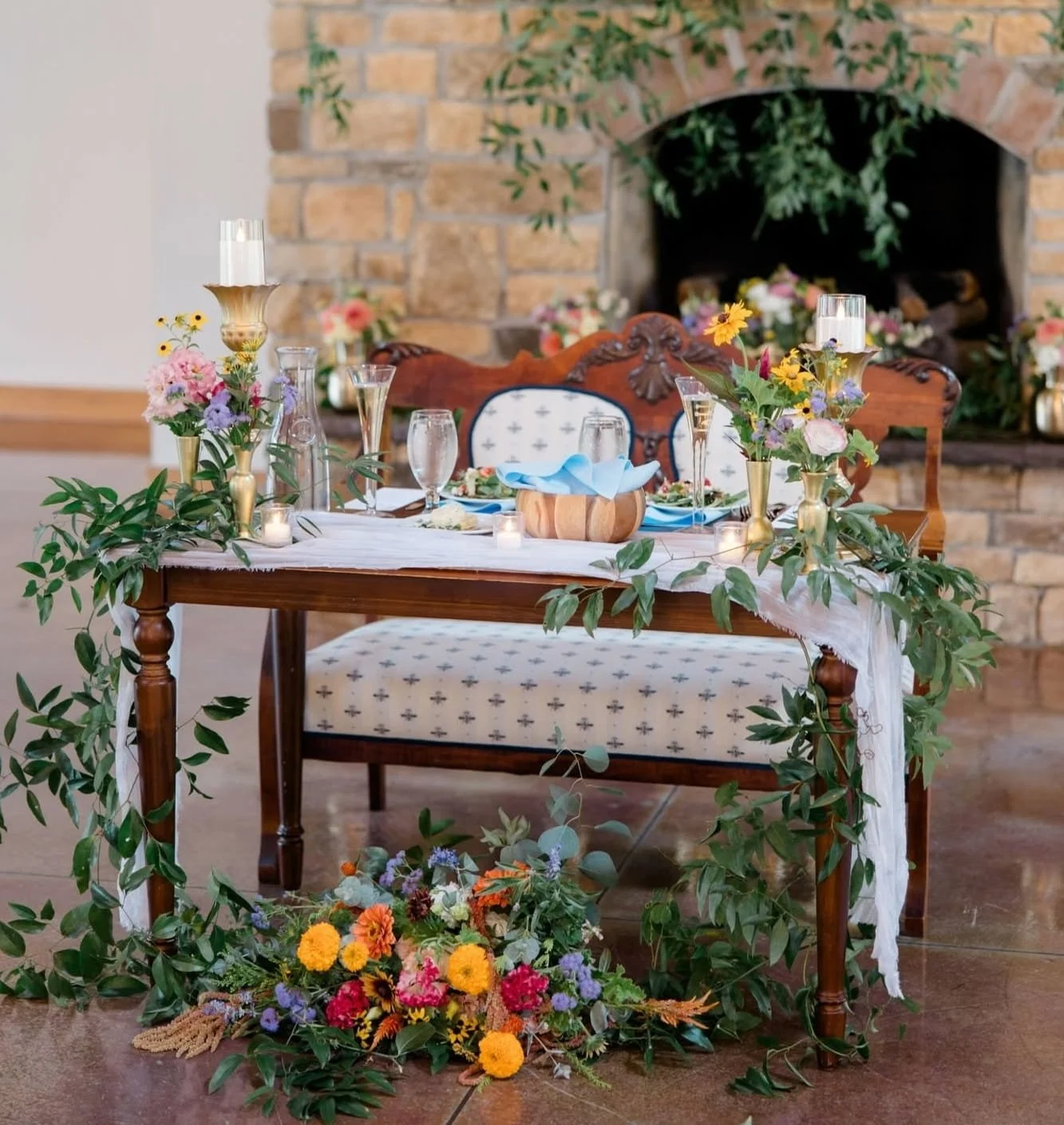 A decorative table showcasing fresh flowers and soft candlelight, enhancing the ambiance for a special wedding occasion.