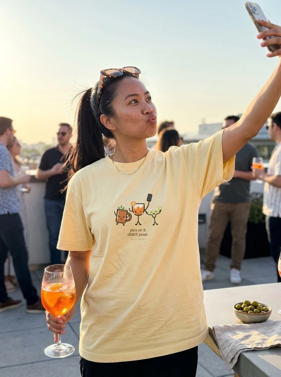 Woman taking a selfie on a rooftop in a Butter The Photo Round tee