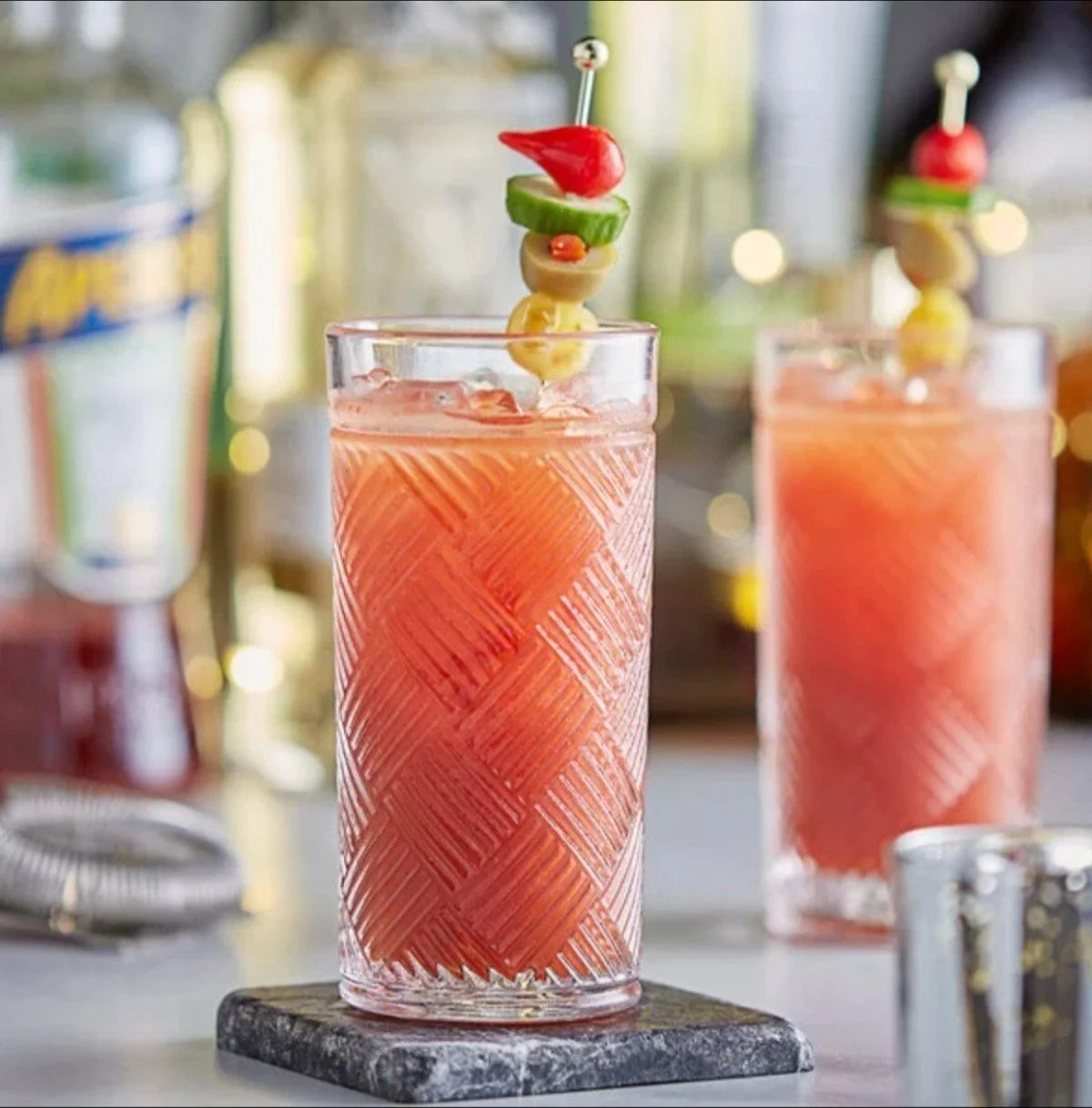 Highball Glass 12oz with a garnished tall cocktail on a stone coaster