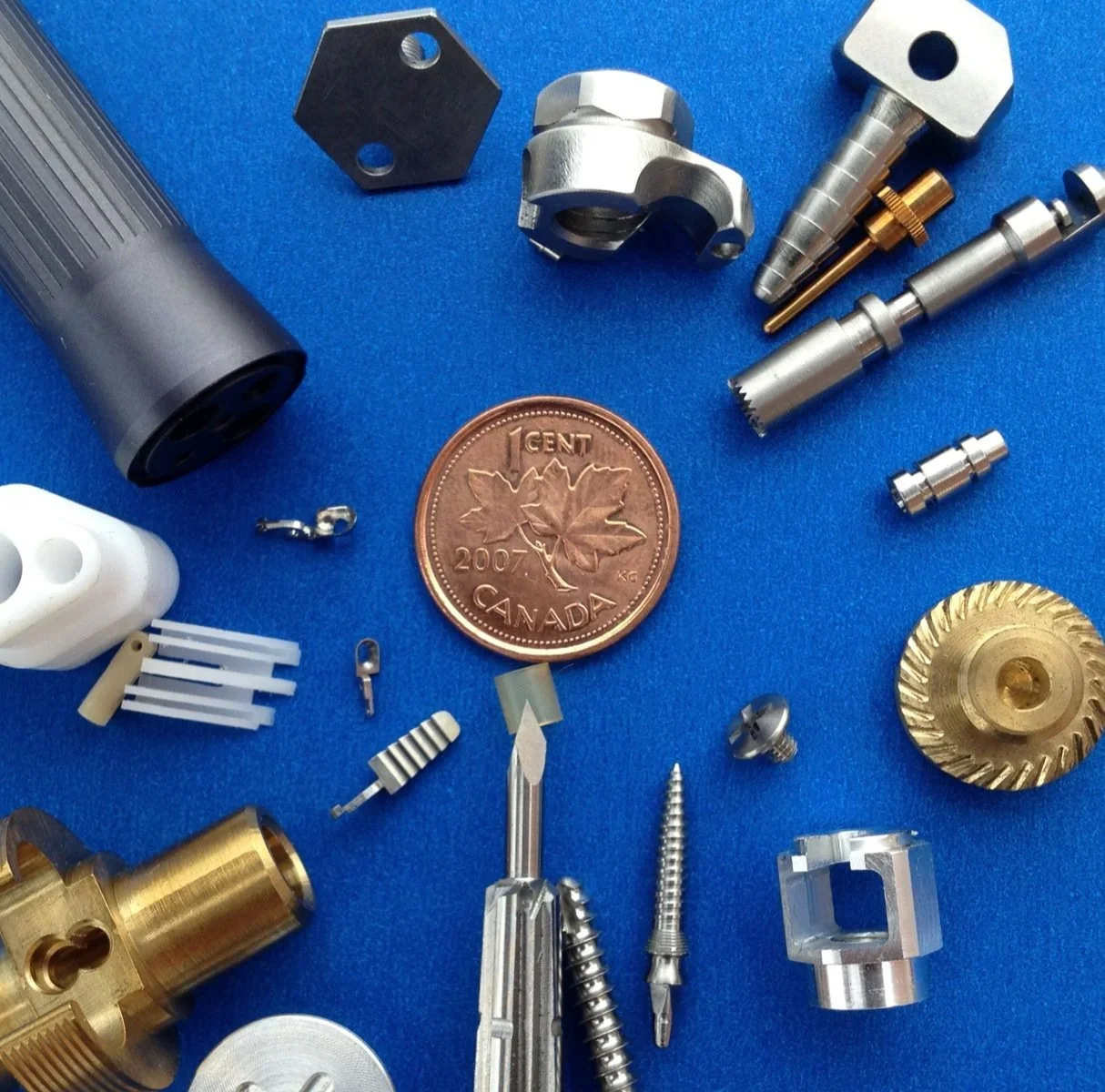 Production parts around a penny