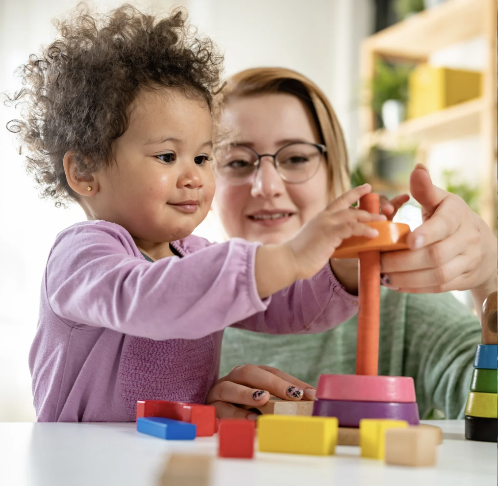 Parent helping toddler develop speech and language skills through interaction in Fayetteville NC