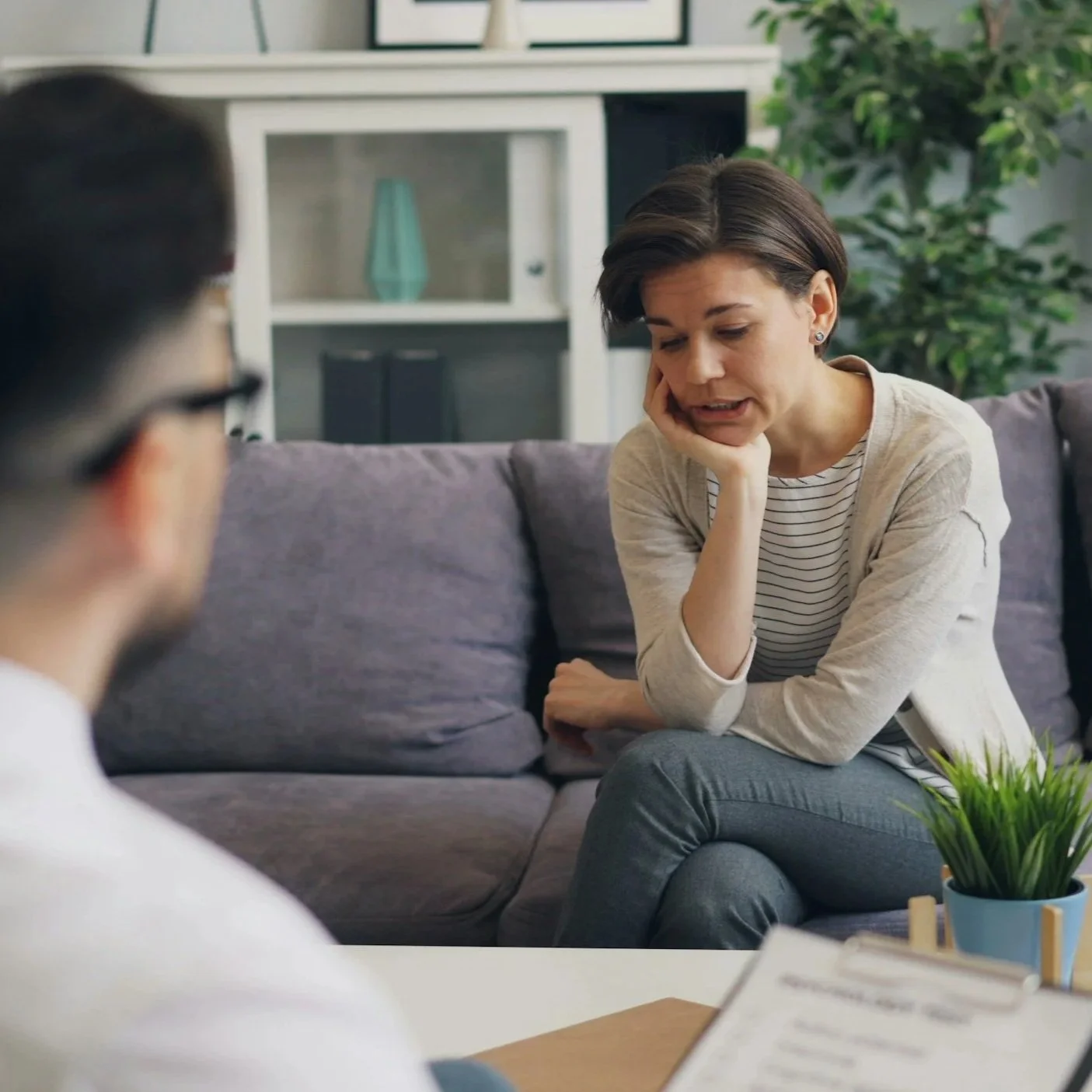 woman sitting on couch talking to therapist