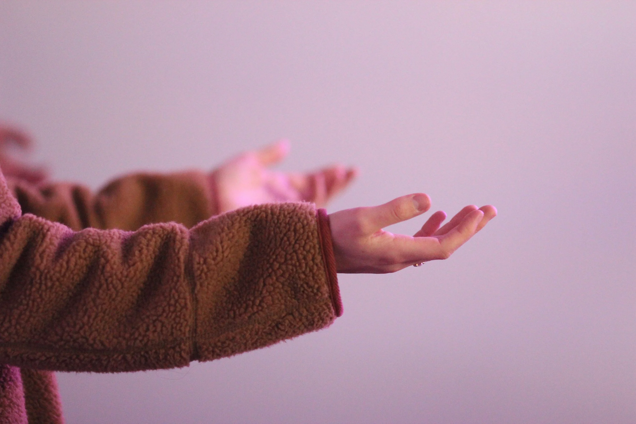 two arms extended with palms up