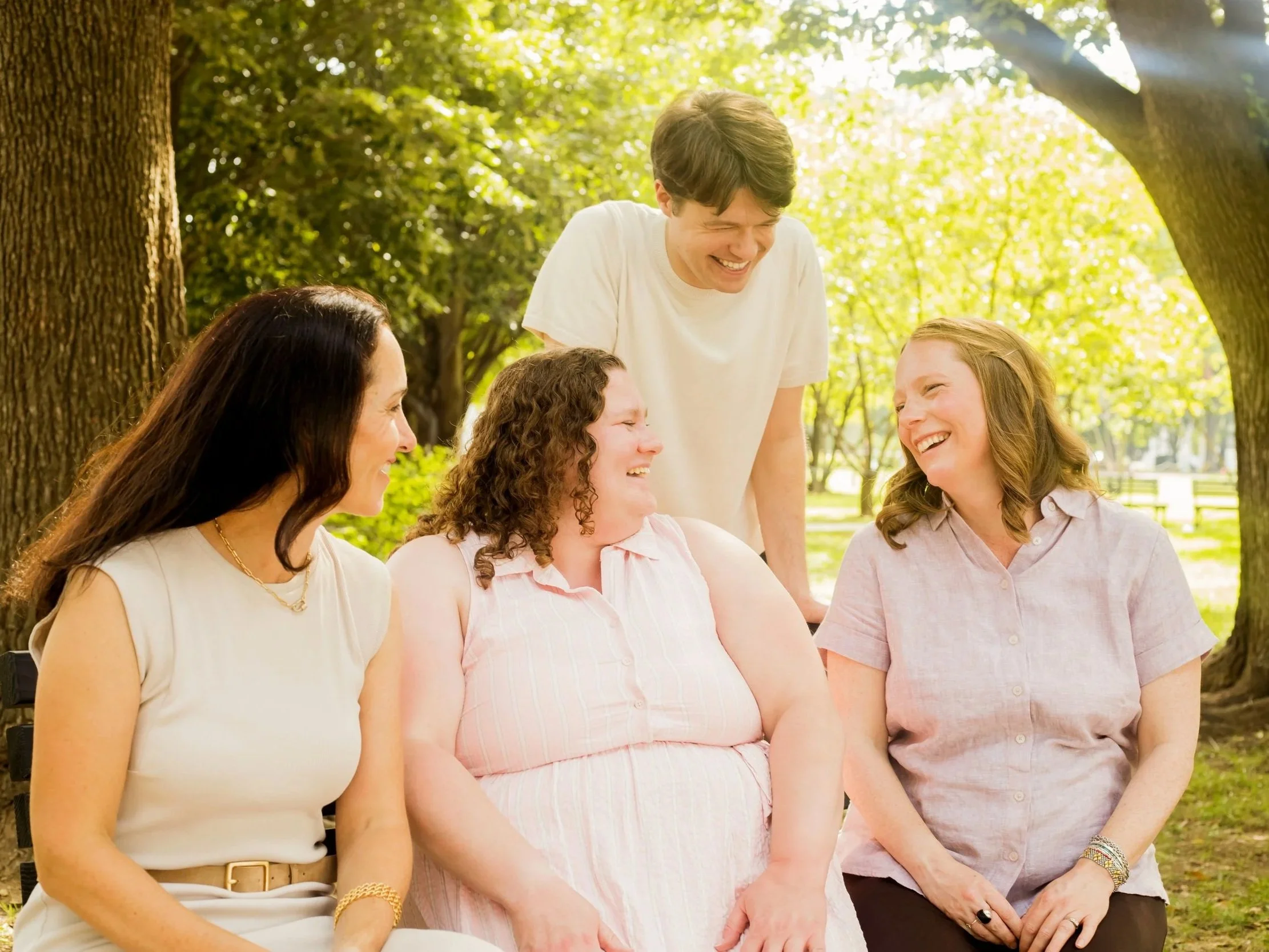 Therapists at Full Self Psychotherapy sitting underneath trees and laughing together