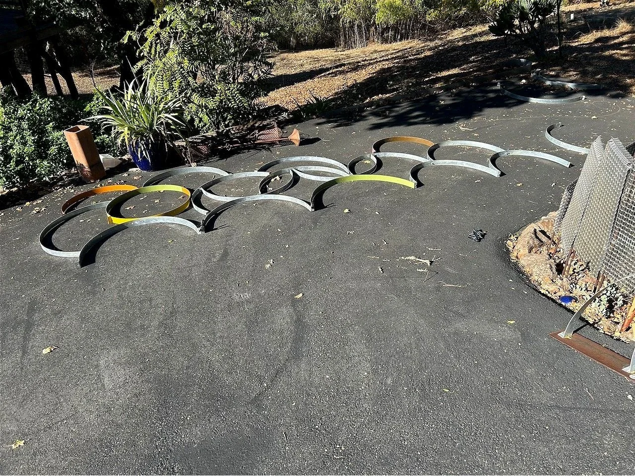 Of course!  More metal art. I had to visualize the result while laying the pieces out on the ground (before painting, which would have scratched things up pretty good), marking for alignment and - the photo!...